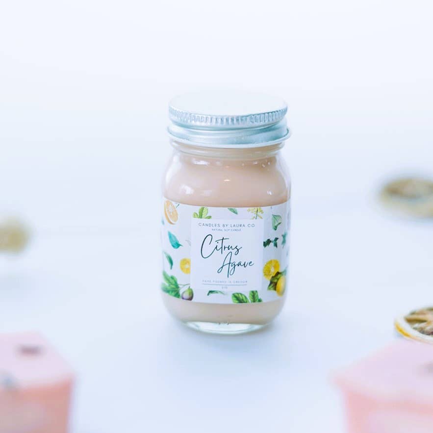 Image of the Citrus Agave candle, a pale pink candle in a miniature mason jar.