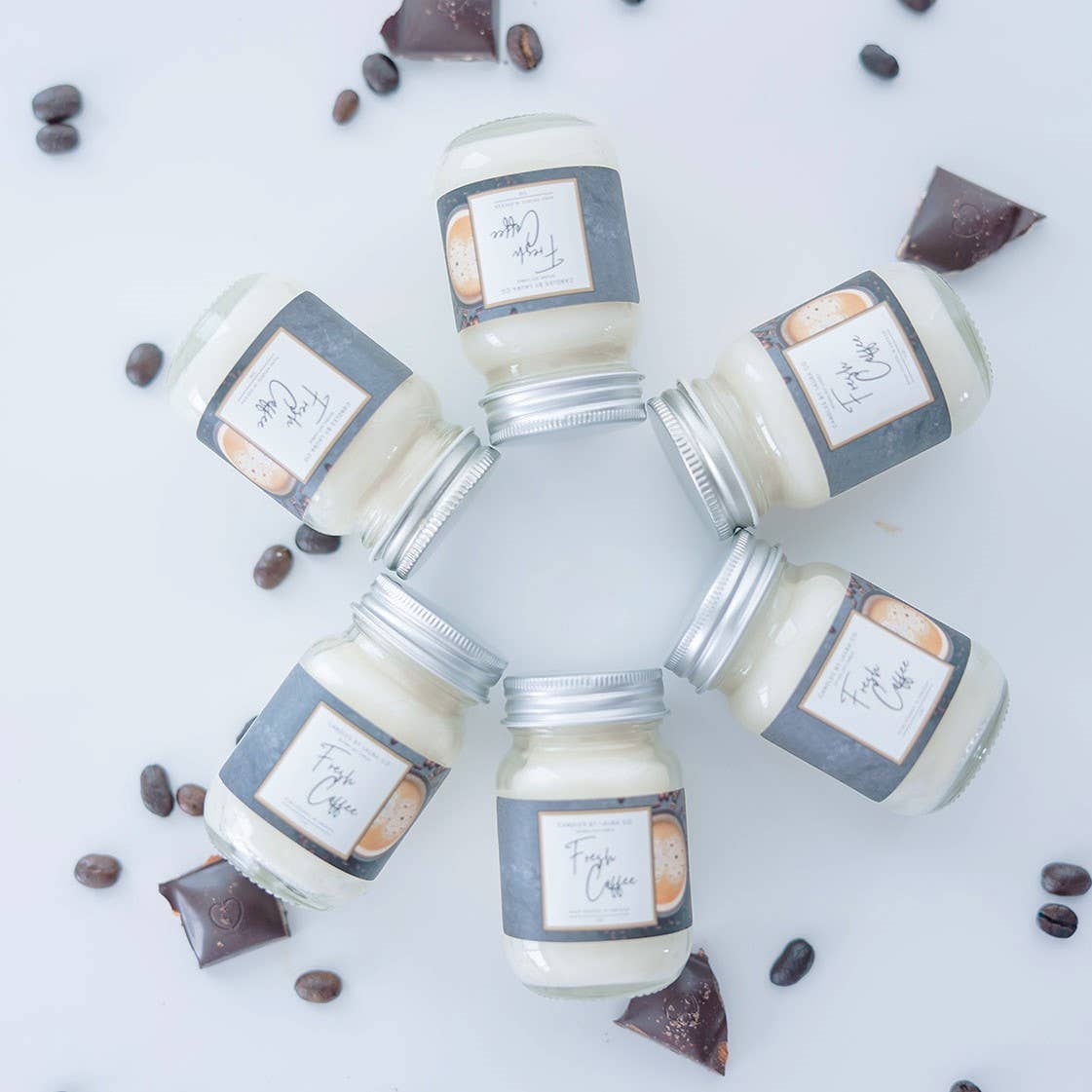 Image of six Fresh Coffee candles, off-white candles in miniature mason jars, laid out in a circle.