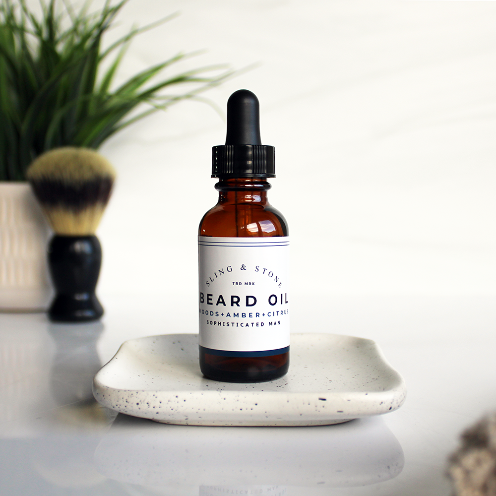 An amber-tinted glass bottle, labeled “Beard Oil”.