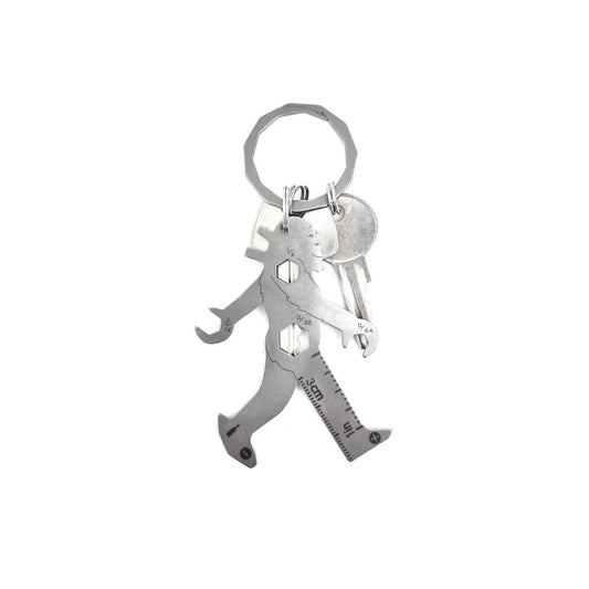 A silver metal multitool, shaped like Bigfoot striding through the trees, hanging on a keychain alongside a few keys.