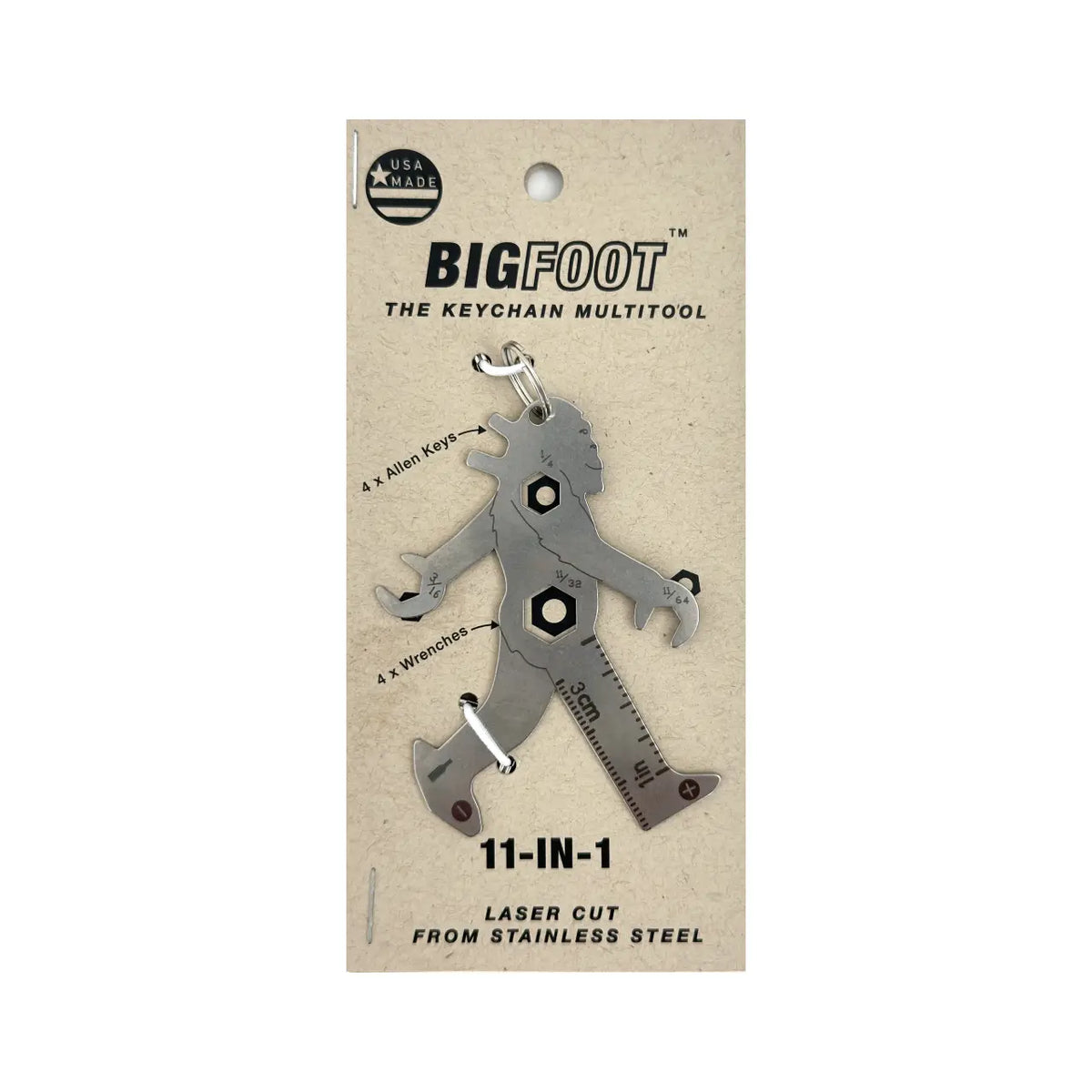 A silver metal multitool shaped like Bigfoot striding through the trees. It is presented with a backing card, displaying some of its features (its two Allen keys and four hex wrenches.)