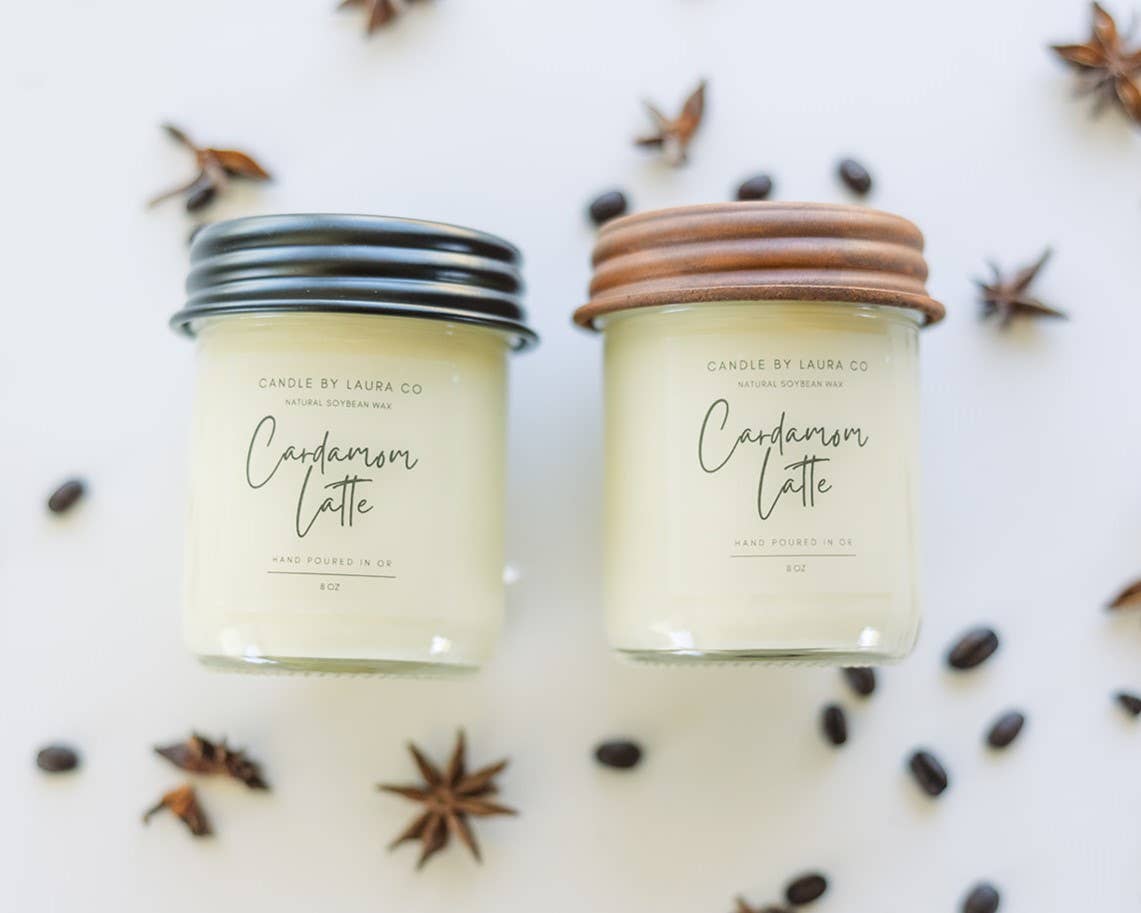 Two off-white candles in glass jars, both labelled “Cardamom Latte.