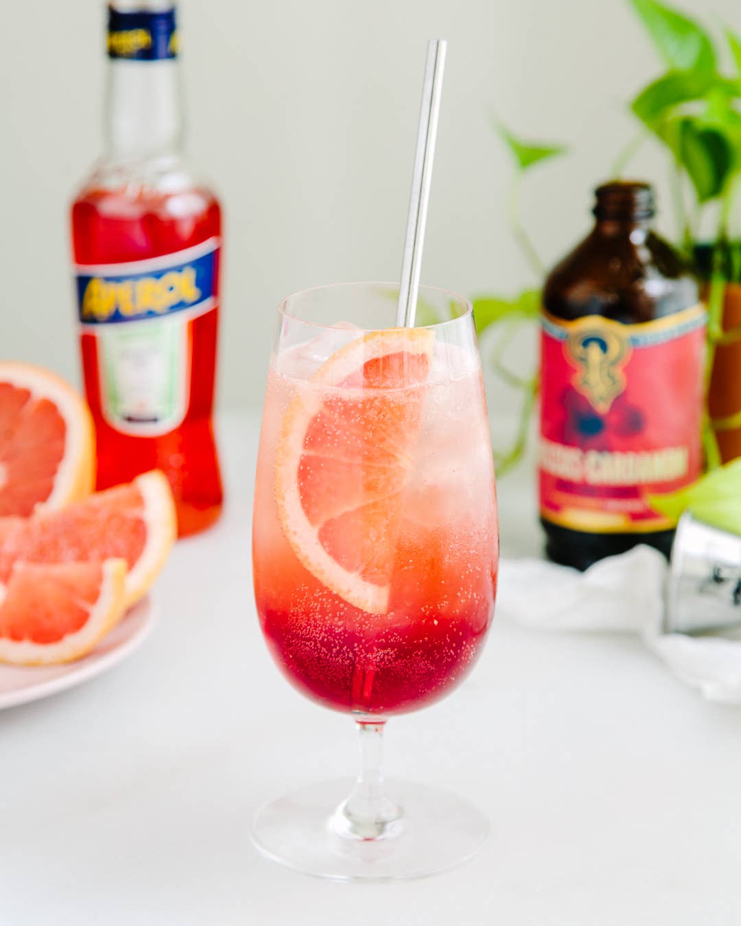 Iced cocktail with straw made from hibiscus-cardamom syrup