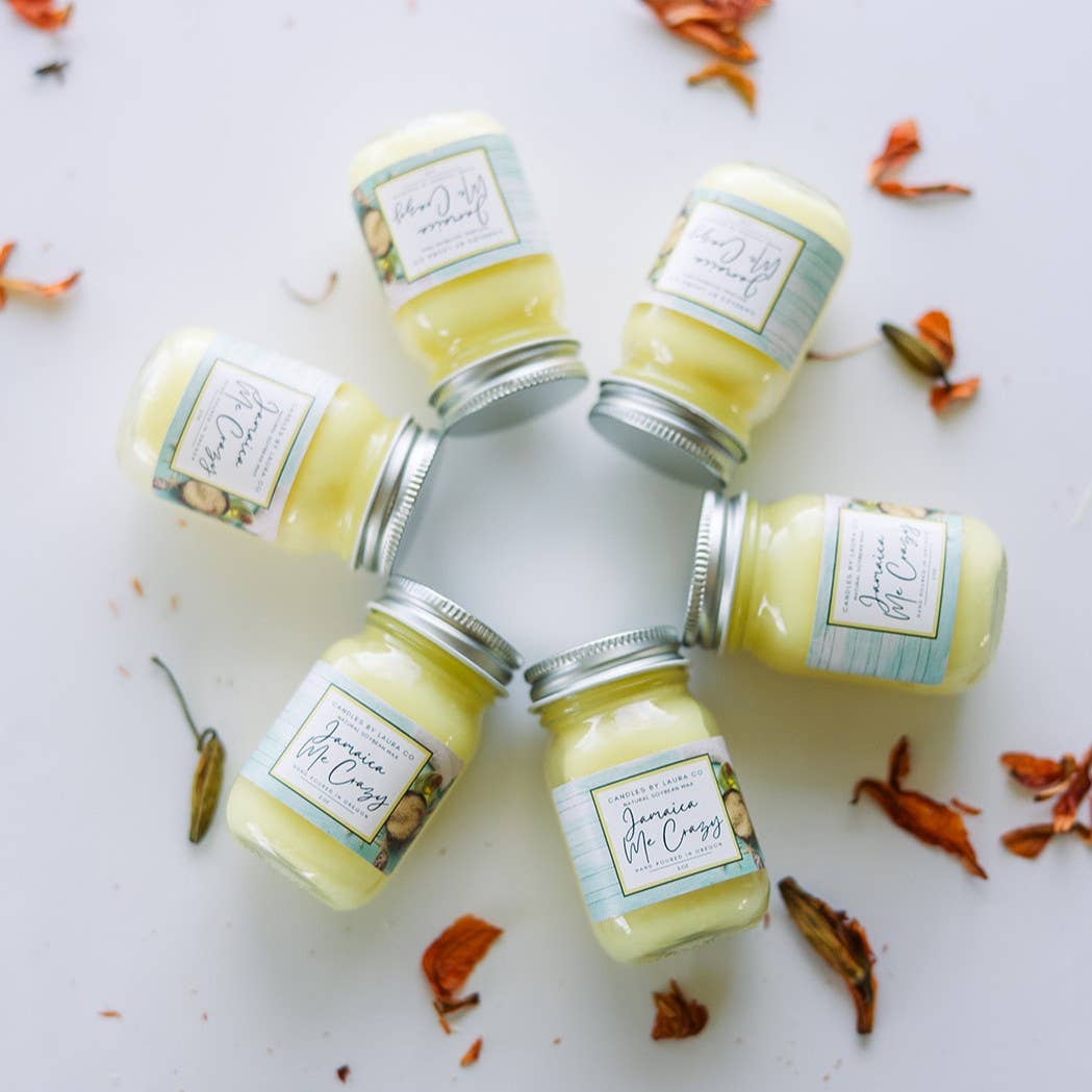 Image of six Jamaica Me Crazy candles, yellow candles in miniature mason jars, laid out in a circle.