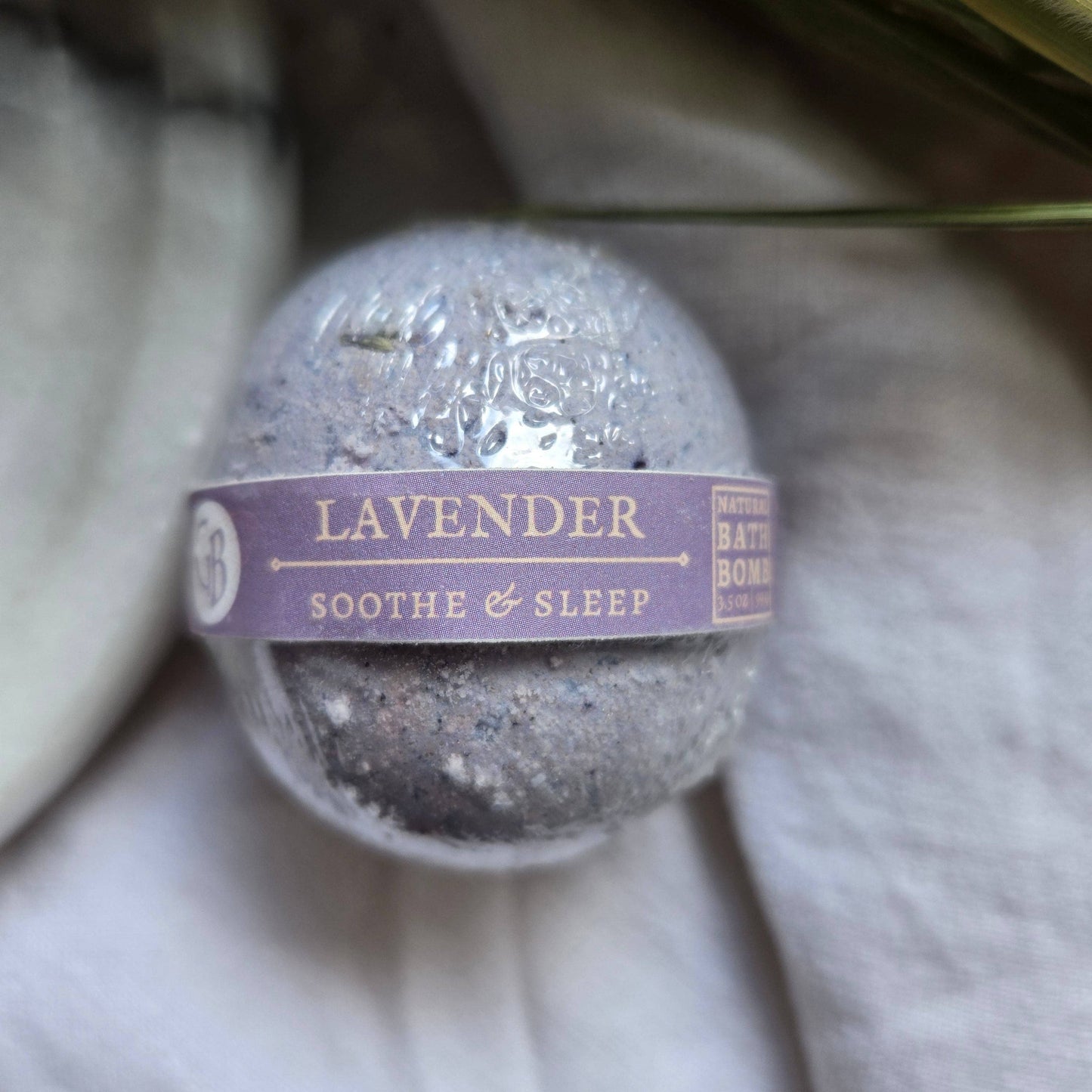 A purple bath bomb labeled “Lavender” with the tagline “Soothe & Sleep”.