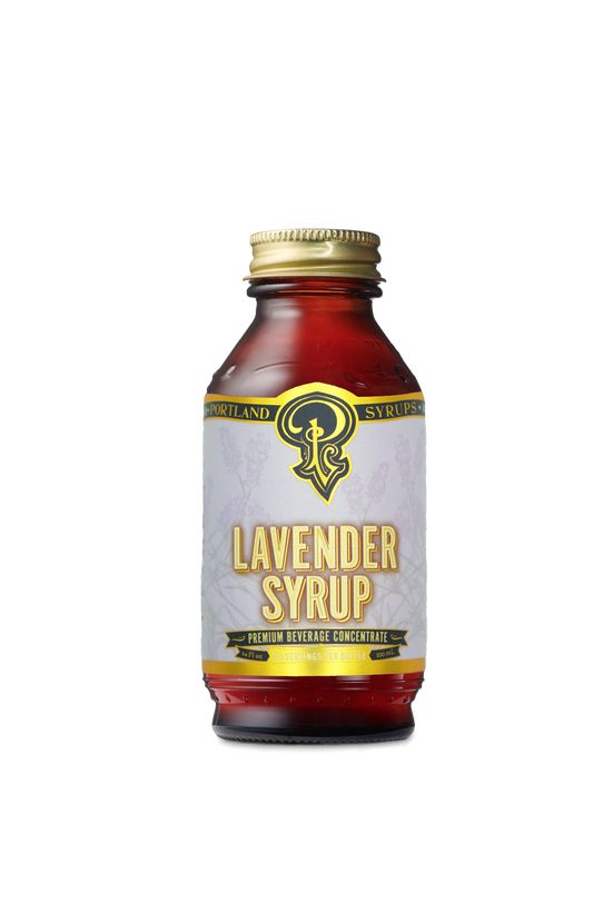 A small, dark, glass bottle, labeled “Portland Syrups - Lavender Syrup - Premium Beverage Concentrate”