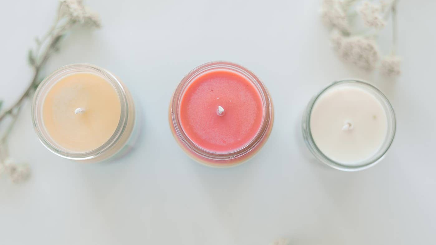 Image showing a cream, red, and white candle, open and viewed from above.