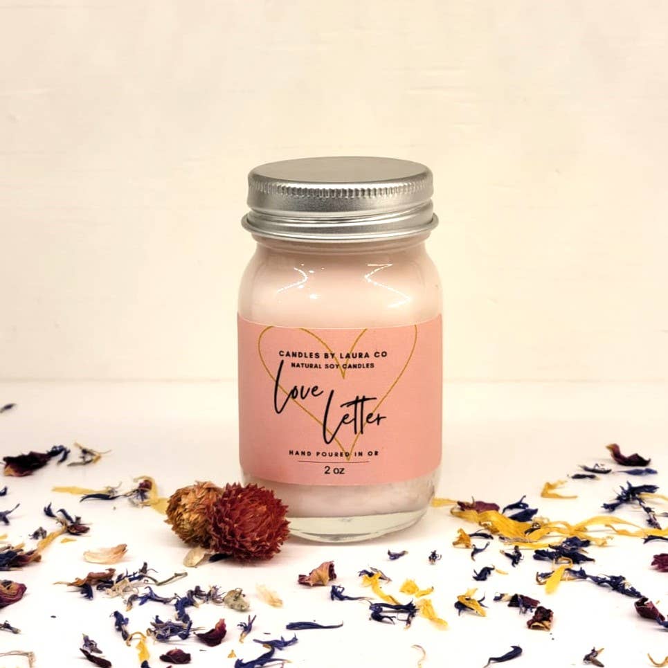 A picture of the Date Night candle, a pale pink candle in a miniature mason jar.