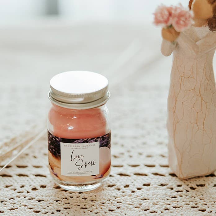 Image of the Love Spell candle, a pink candle in a miniature mason jar.