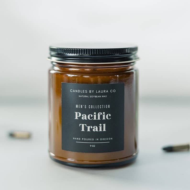 A candle in an amber-tinted jar, labeled “Pacific Trail”.