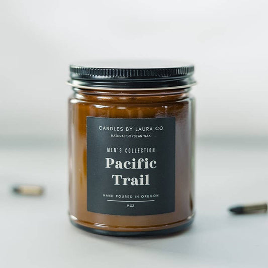 A candle in an amber-tinted jar, labeled “Pacific Trail”.