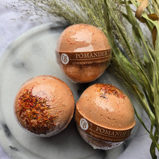 A trio of Pomander bath bombs, orange bath bombs tapped with safflower petals.