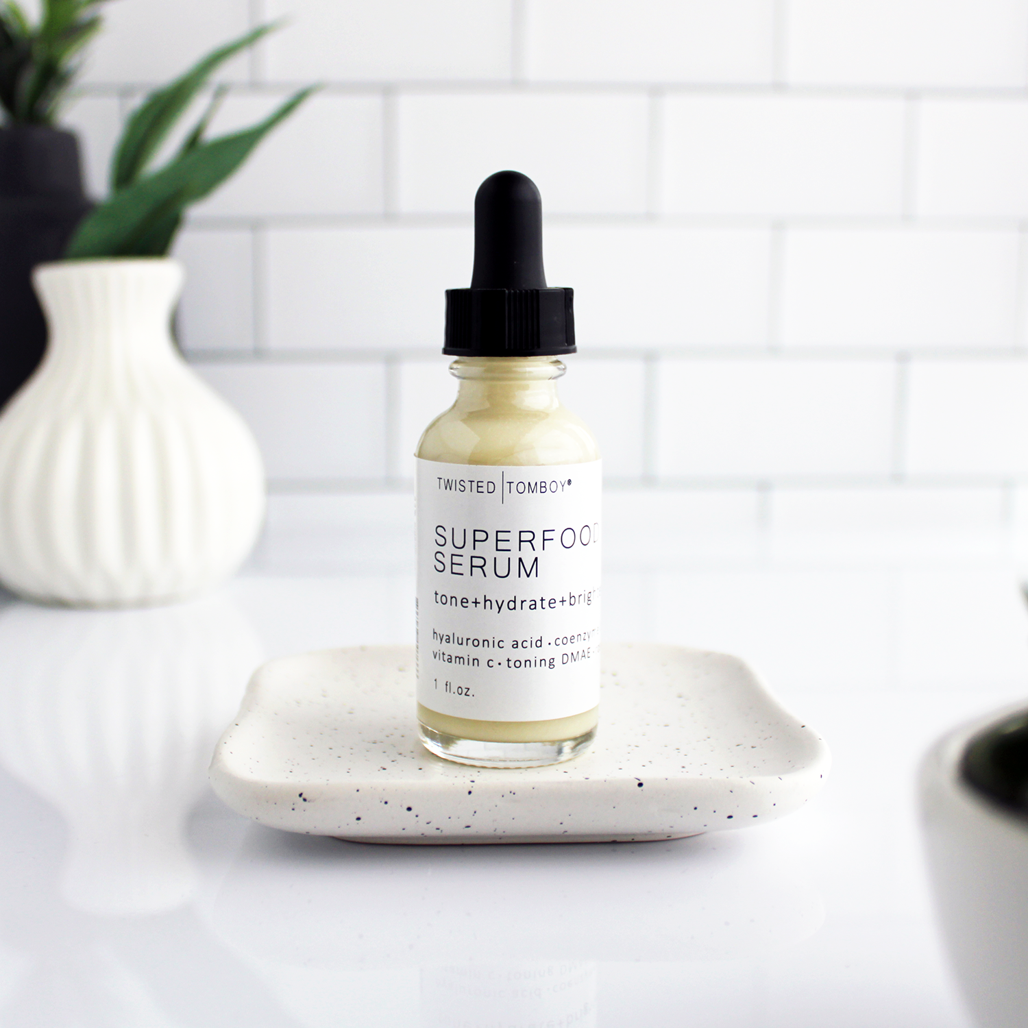 An eggshell-colored liquid or lotion in a small bottle labeled “Superfood Serum”.