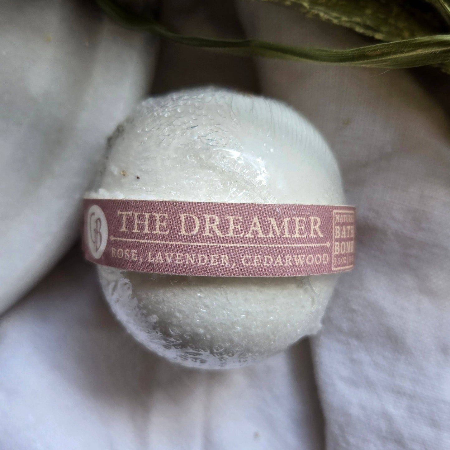 A single The Dreamer bath bomb, a white bath bomb.