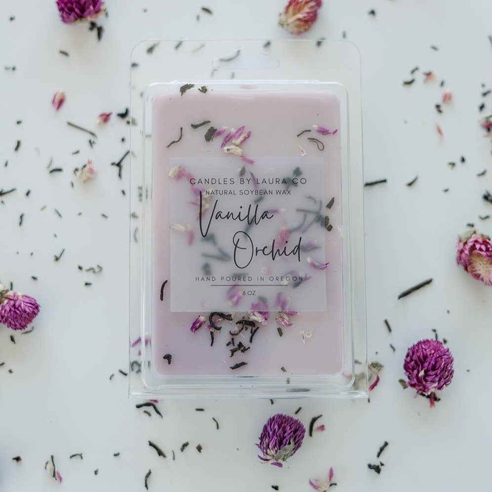 Image of the Vanilla Orchid wax melt, a pale lavender wax with shredded flowers decorating it.
