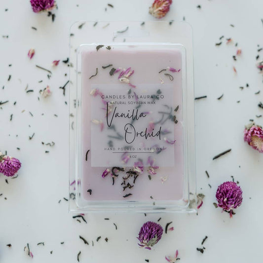 Image of the Vanilla Orchid wax melt, a pale lavender wax with shredded flowers decorating it.