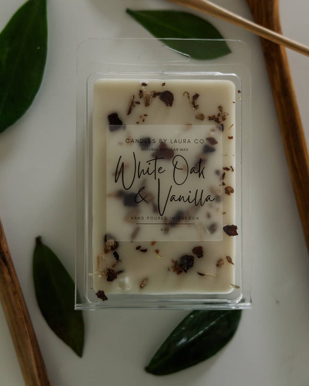 Image of the White Oak & Vanilla wax melt, a cream-colored wax with pieces of oak bark and vanilla bean suspended in it.