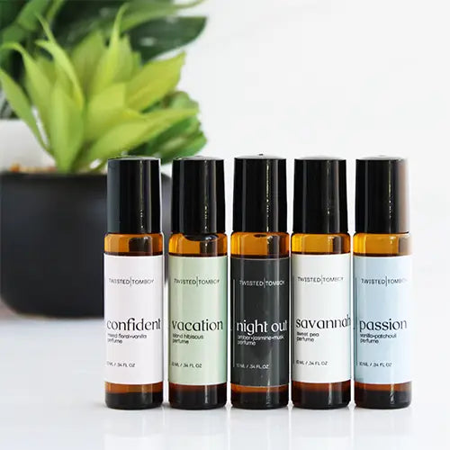 Five slender bottles of perfume. From left to right, they are labeled “confident”, “vacation,” “night out”, “savannah”, and “passion”.